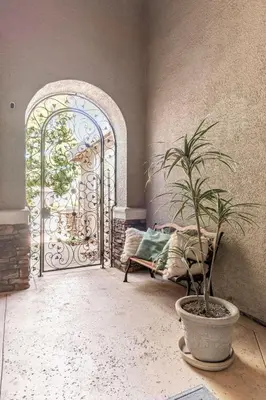 a room with a gate and a potted plant and a bench at Rose Garden in Sacramento