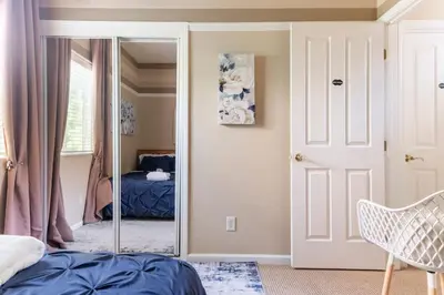 a bedroom with a mirror and a door with a bed at Rose Garden in Sacramento