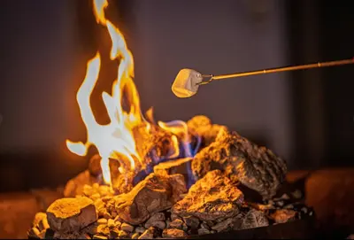 a spatula being held over a fire with a stick at Stovepipe Wells Village in Death Valley