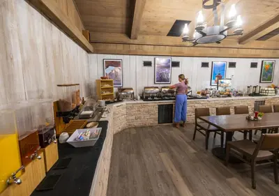 a woman standing in a kitchen with a stove at Stovepipe Wells Village in Death Valley