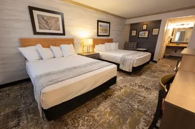 a hotel room with two beds and a desk at Stovepipe Wells Village in Death Valley