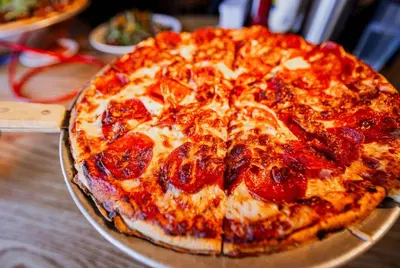 a pepperoni pizza sitting on top of a table at Stovepipe Wells Village in Death Valley