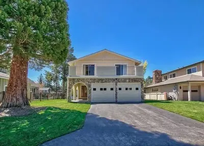 a large house with a tree and a driveway at 2148 Inverness Drive home in South Lake Tahoe