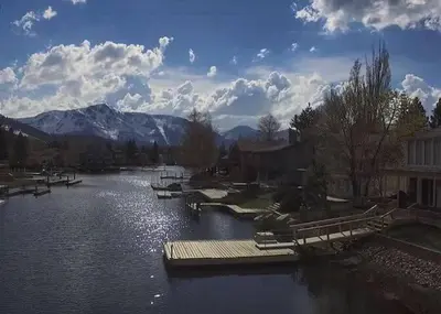 a river with a dock and boats in the water at 2148 Inverness Drive home in South Lake Tahoe