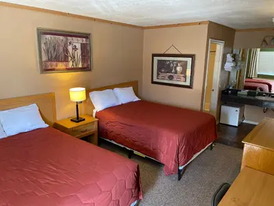a hotel room with two beds and a sink at Whitney Portal Hotel And Hostel in Lone Pine