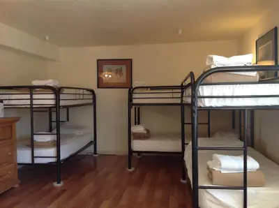 a room with four bunk beds in it at Whitney Portal Hotel And Hostel in Lone Pine
