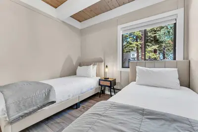 two beds in a room with a window at Modern Incline Village Escape Near Lake and Trails in Incline Village