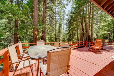a wooden deck with a table and chairs on it at Hike and Ski! Cabin 20 Mi to Soda Springs Mtn Resort in Emigrant Gap