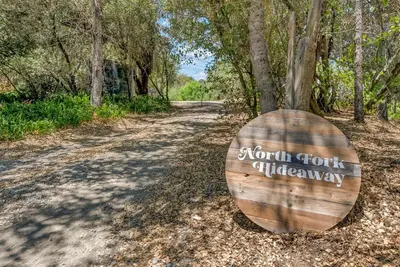a wooden barrel sitting on the side of a road at New Listing! North Fork Hideaway Sleeps 14! in Three Rivers
