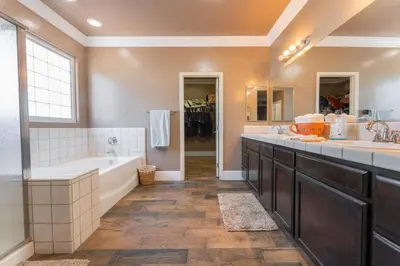 a large bathroom with two sinks and a tub and a tub at Private room--Ideal for working professionals-- in Tulare