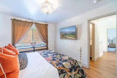 a bedroom with a bed and a window at The Deco Retreat - UNR - Pet Friendly in Reno