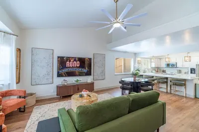 a living room with a couch and a table at The Deco Retreat - UNR - Pet Friendly in Reno
