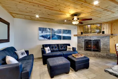 a living room with couches and a fireplace at Tall Pine Chalet home in Stateline