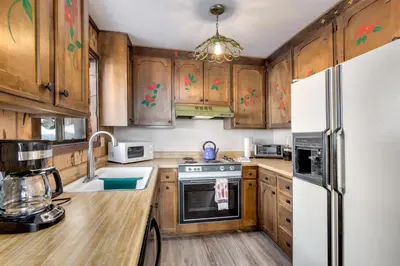 a kitchen with wooden cabinets and a white refrigerator at Snowflake Chalet condo in Stateline