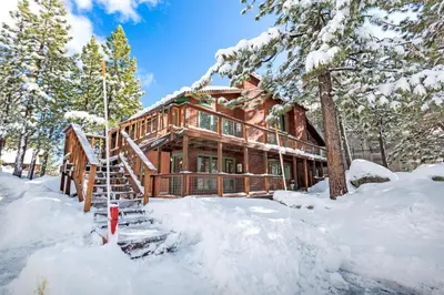 a log cabin in the snow at Snowflake Chalet condo in Stateline