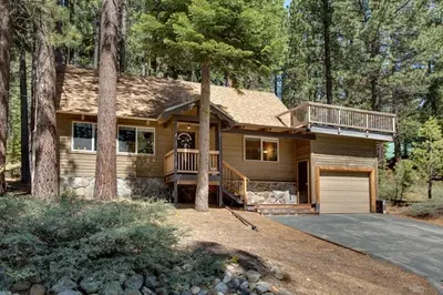 a wooden house with a porch and a garage at Sagebrush Cottage chalet in South Lake Tahoe