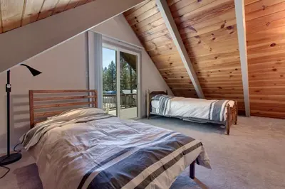 a bedroom with a bed and a large window at Sagebrush Cottage chalet in South Lake Tahoe
