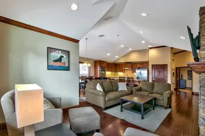 a living room with couches and a table at Conifer Chalet condo in South Lake Tahoe
