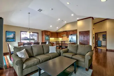 a living room with a couch and a table at Conifer Chalet condo in South Lake Tahoe