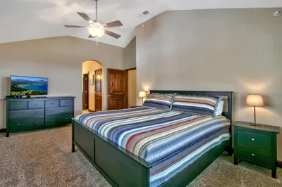a bedroom with a bed and a ceiling fan at Conifer Chalet condo in South Lake Tahoe