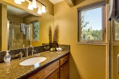 a bathroom with a sink and a window at Tudor Lodge home in Stateline