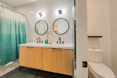 a bathroom with a sink and two mirrors at Twilight Run at Palisades by Tahoe Getaways - Pet-Friendly 3BR w EV Charger & Ski Shuttle in Olympic Valley
