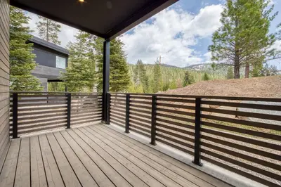 a large deck with a view of the mountains at Twilight Run at Palisades by Tahoe Getaways - Pet-Friendly 3BR w EV Charger & Ski Shuttle in Olympic Valley
