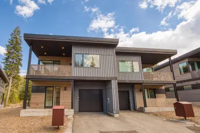 a large house with a driveway at Twilight Run at Palisades by Tahoe Getaways - Pet-Friendly 3BR w EV Charger & Ski Shuttle in Olympic Valley