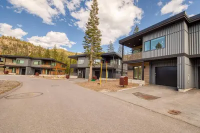 a house with a tree in the middle of a driveway at Twilight Run at Palisades by Tahoe Getaways - Pet-Friendly 3BR w EV Charger & Ski Shuttle in Olympic Valley