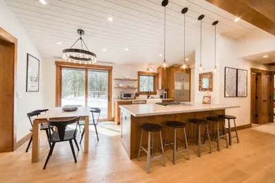 a kitchen with a large island with bar stools at Splendid at Chamberlands by Tahoe Getaways - Chamberlands HOA, Private Hot Tub & Walk to Lake Tahoe in Tahoma