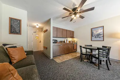 a living room with a couch and a dining room table at Beautiful Studio W/Kitchenette #134 at Donner Lake Village in Truckee
