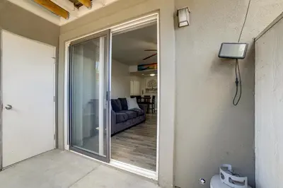a view of a living room with a sliding glass door at 3 Mi to Dtwn Gated Condo with Patio in Reno! in Reno