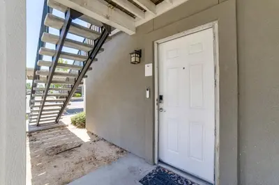 a white door to a house with a staircase at 3 Mi to Dtwn Gated Condo with Patio in Reno! in Reno