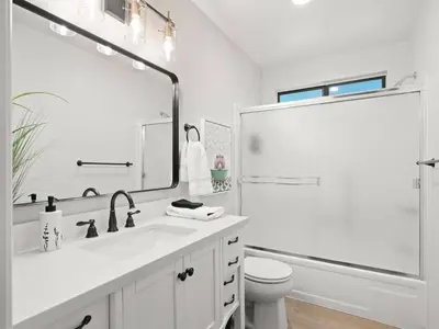a white bathroom with a sink and a shower at Mountain retreat w FirePit, BBQ, Karaoke, PingPong in Arnold
