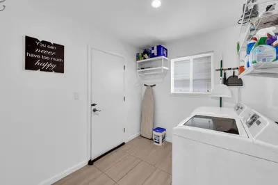 a kitchen with a washer and dryer in a room at Reno Retreat-Near Downtown-UNR-Family Fun in Reno