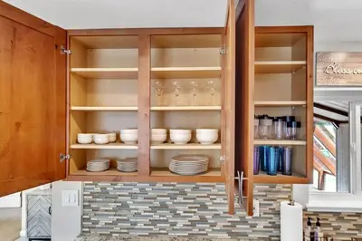a kitchen cabinet with plates and dishes in it at Reno Retreat-Near Downtown-UNR-Family Fun in Reno