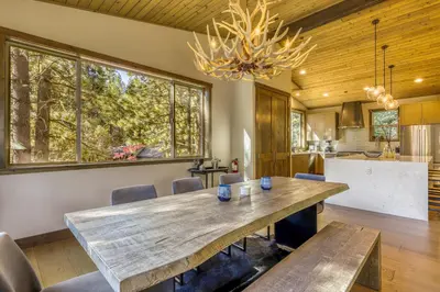a dining room with a large wooden table and chairs at The Lodge at Silverado in Tahoe City