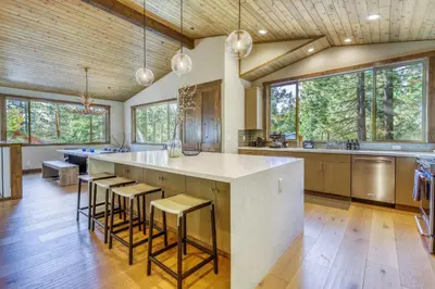 a kitchen with a large island with bar stools at The Lodge at Silverado in Tahoe City