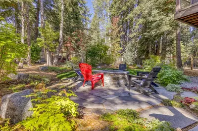 two red chairs sitting on a patio in a garden at The Lodge at Silverado in Tahoe City