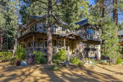 a large wooden house with trees in front of it at The Lodge at Silverado in Tahoe City