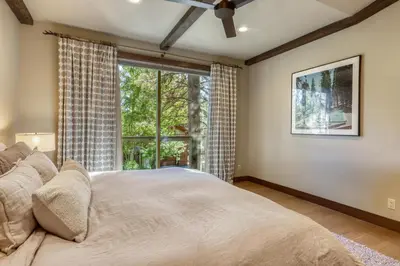 a bedroom with a bed and a large window at The Lodge at Silverado in Tahoe City