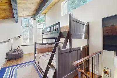 a room with a staircase and a bunk bed at Cozy Bear Retreat in Kings Beach