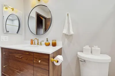 a bathroom with a sink and a toilet and a mirror at Cozy Bear Retreat in Kings Beach