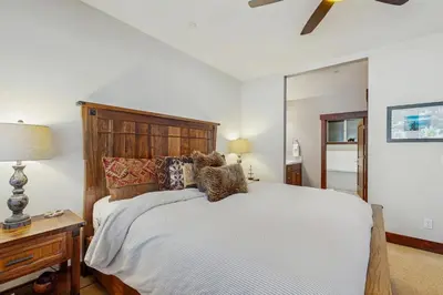 a bedroom with a large bed with a wooden headboard at TruckeeTime in Truckee