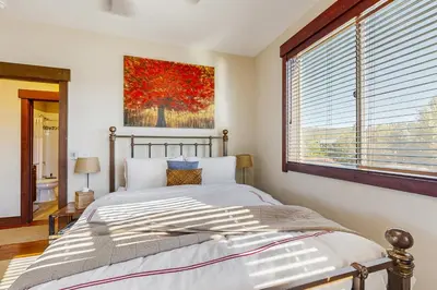 a bedroom with a bed and a large window at TruckeeTime in Truckee