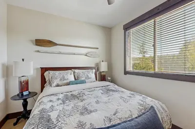 a bedroom with a bed and a large window at TruckeeTime in Truckee