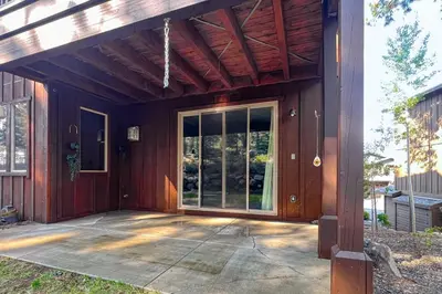 a screened in porch of a house with a glass door at TruckeeTime in Truckee