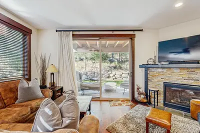 a living room with a couch and a fireplace at TruckeeTime in Truckee