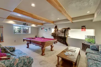 a living room with a pool table in it at Sequoia Chalet home in Stateline