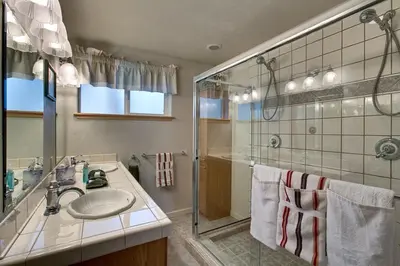 a bathroom with a sink and a shower at Sequoia Chalet home in Stateline
